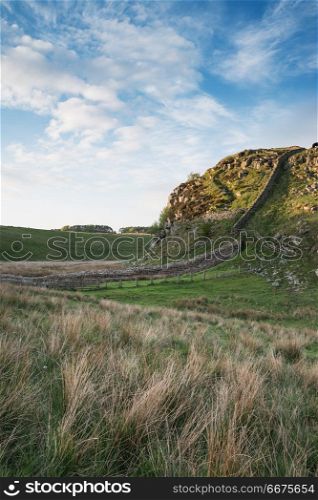 Beautiful landscape image of Hadrian&rsquo;s Wall in Northumberland at. Stunning landscape image of Hadrian&rsquo;s Wall in Northumberland at sunset with fantastic late Spring light