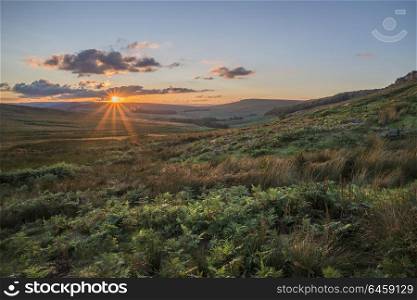 Beautiful landscape image of Stanage Edge during Summer sunset in Peak District Egland