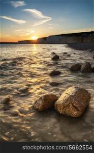 Beautiful landscape image of sunset over Birling Gap in England