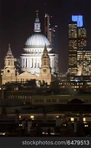 Beautiful landscape image of the London skyline at night looking. England, London, St Paul&rsquo;s Cathedral. St Paul&rsquo;s Cathedral in London at night.. Landscape image of the London skyline at night looking along the River Thames