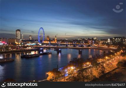 Beautiful landscape image of the London skyline at night looking. England, London, London. The London skyline at night.. Landscape image of the London skyline at night looking along the River Thames