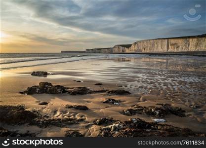 Beautiful landscape image of white chalk cliffs with colorful vibrant sunset on English coast