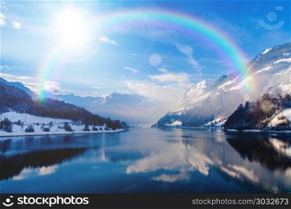 beautiful landscape in winter with rainbow