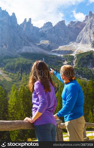 beautiful landscape. man and girl are looking at the mountains. Dolomites, Italy