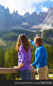 beautiful landscape. man and girl are looking at the mountains. Dolomites, Italy