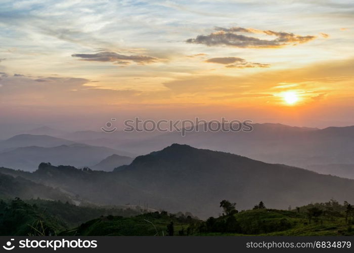 Beautiful landscape nature on mountain with sun cloud fog and bright colors of sky and sunlight during sunset in winter at view point Phu Chi Fa Forest Park in Chiang Rai Province, Thailand