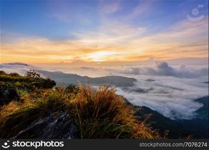 Beautiful landscape nature, sunrise on peak mountain with sun cloud fog and bright colors of sky in winter at Phu Chi Fa Forest Park is a famous tourist attraction of Chiang Rai Province, Thailand