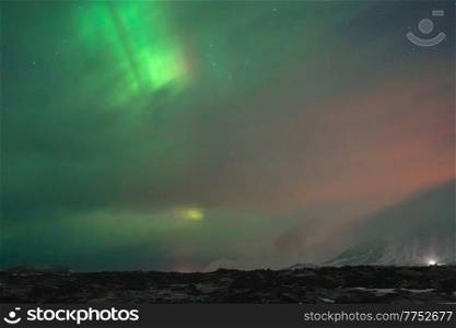 Beautiful Landscape of a Bright Green Northern Light in the Sky. Amazing View of Aurora Borealis. Unique Nature of Iceland.. Beautiful Sky with Aurora Borealis