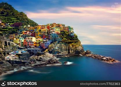 Beautiful landscape of a coastal fishing village, amazing view on many little colorful houses, traditional architecture of the little Italian town called Cinque Terre