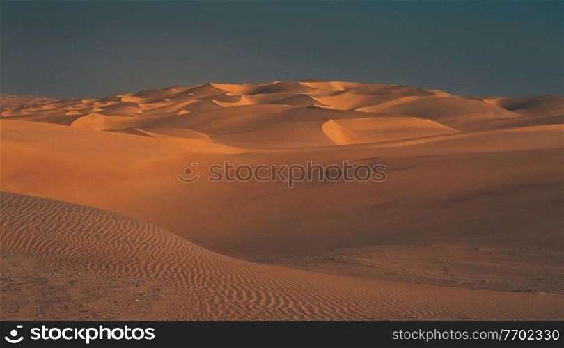 Beautiful Landscape of a Desert. Vast Sandy Dunes Expands into Wildlands. Mild Sunset Lights. Liwa Desert. Abu Dhabi. United Arab Emirates.