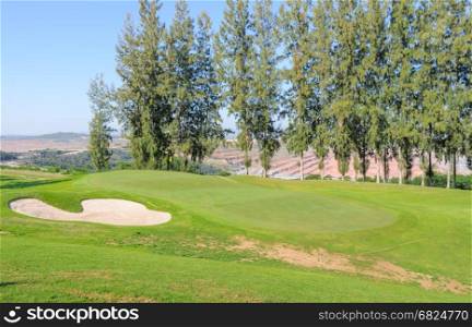 Beautiful landscape of a golf court with pine trees in Thailand