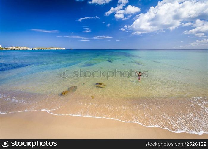 Beautiful landscape of a portuguese beach with a woman on the sea