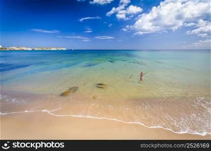 Beautiful landscape of a portuguese beach with a woman on the sea