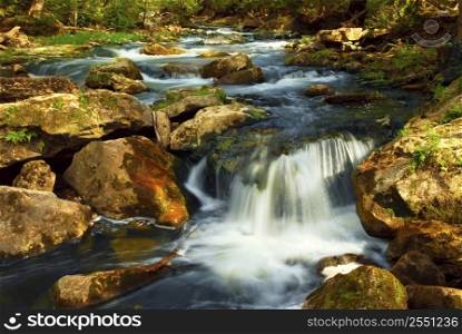 Beautiful landscape of a river cascading over rocks in wilderness
