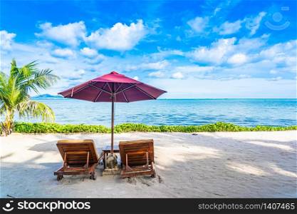 Beautiful landscape of beach sea ocean with empty chair deck and umbrella nearly coconut palm tree with white cloud and blue sky for leisure travel in holiday vacation