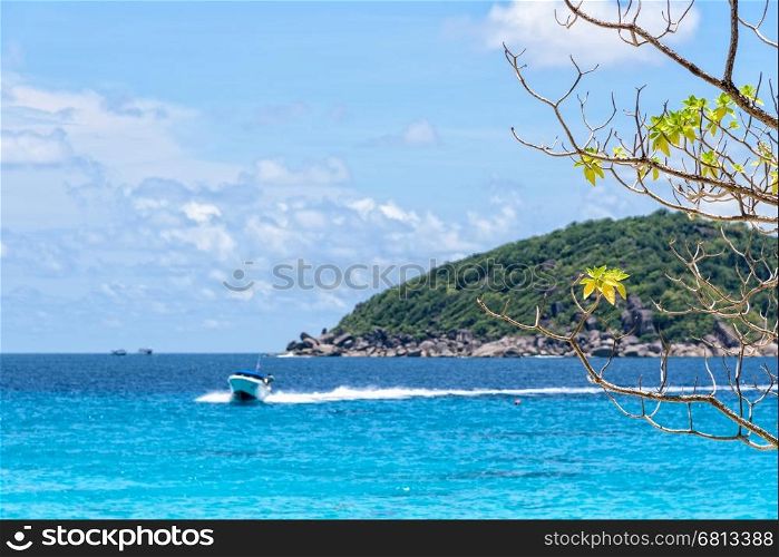 Beautiful landscape of blue sea and speed boat taking tourists traveling to Koh Miang Island under the summer sky for background in Mu Ko Similan National Park, Phang Nga Province, Thailand