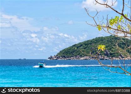 Beautiful landscape of blue sea and speed boat taking tourists traveling to Koh Miang Island under the summer sky for background in Mu Ko Similan National Park, Phang Nga Province, Thailand