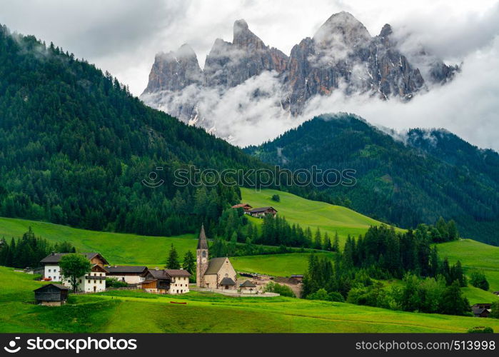 Beautiful landscape of Dolomites Italy with the Church of St. Magdalena or Santa Maddalena in the green Val di Funes Valley and the Geissler Spitzen in the background