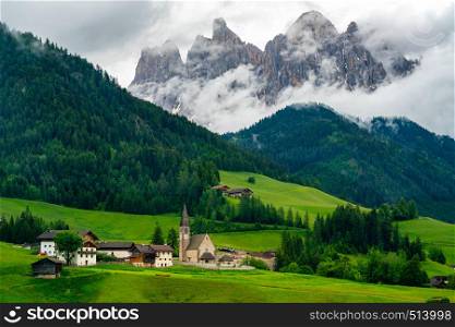 Beautiful landscape of Dolomites Italy with the Church of St. Magdalena or Santa Maddalena in the green Val di Funes Valley and the Geissler Spitzen in the background