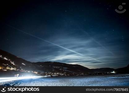 Beautiful landscape of high Austrian Alps covered by snow at starry night