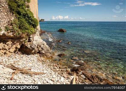 Beautiful landscape of high cliff on sea beach at sunny day