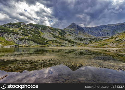 Beautiful landscape of mountain lake with algae in Rila mountain, Bulgaria