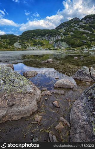 Beautiful landscape of mountain lake with algae in Rila mountain, Bulgaria. Vertical view