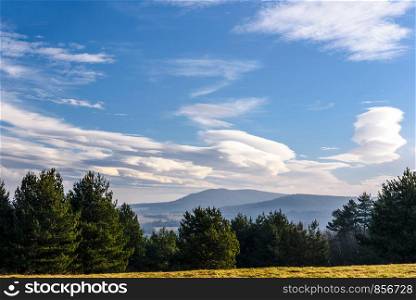 Beautiful landscape of mountains in autumn with a picturesque blue sky and clouds