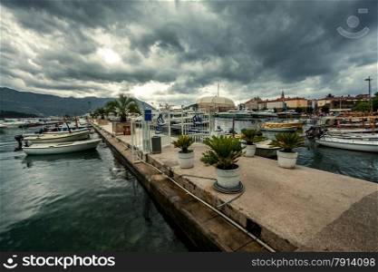 Beautiful landscape of sea port with moored yachts at rainy day
