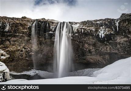Beautiful landscape of Seljalandsfoss waterfall, located in South Region of Iceland, amazing wintertime nature, beauty and strength of wild nature