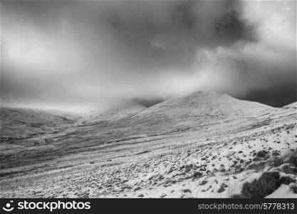 Beautiful landscape of snow covered mountain in Winter in black and white