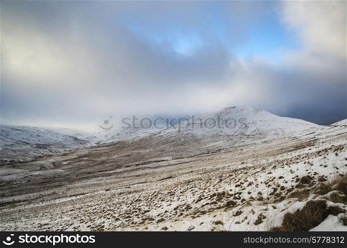 Beautiful landscape of snow covered mountain range during late afternoon in Winter