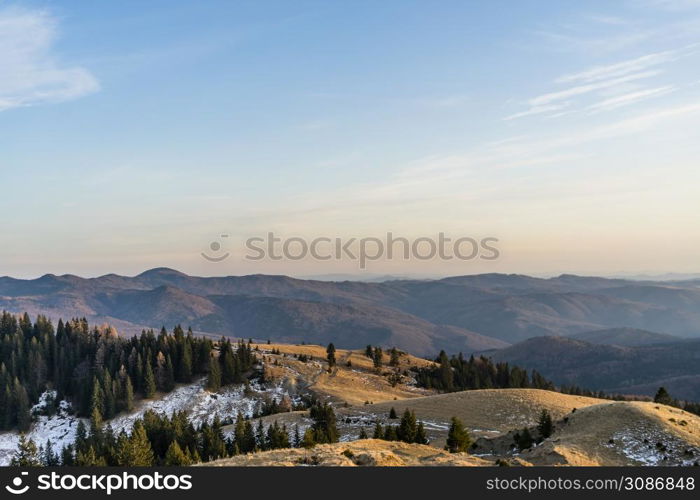 Beautiful landscape of snowy mountains. Beautiful winter nature landscape amazing mountain view. mountain range and pine tree forest with thin snow.