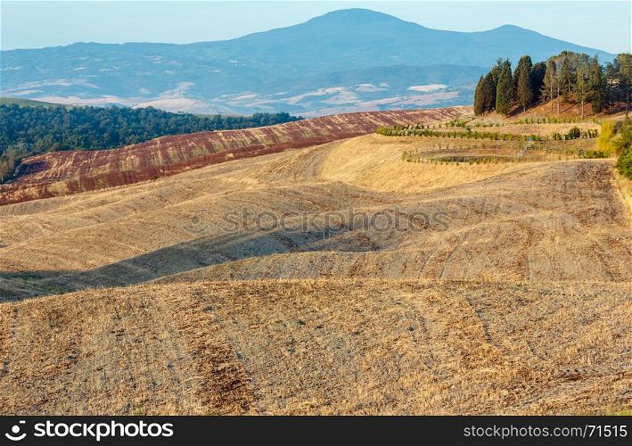 Beautiful landscape of summer morning sunrise countryside in Italy with hills and wheat field.