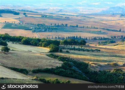 Beautiful landscape of summer morning sunrise countryside with hills, whead field, olives garden, vineyard.