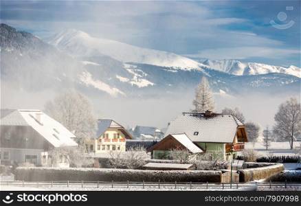 Beautiful landscape of traditional Austrian town in mountains covered by snow