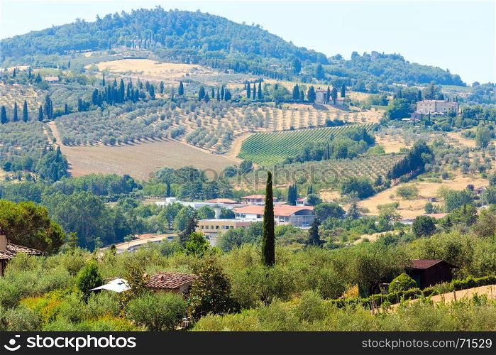 Beautiful landscape of Tuscany summer countryside from Pienza town walls. Typical for the Italy region Toscana hills, wheat field, olives garden, vineyards, cypress passes.