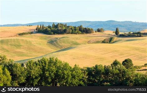 Beautiful landscape of Tuscany summer evening countryside in Italy. Typical for the region Toscana hills, wheat field.