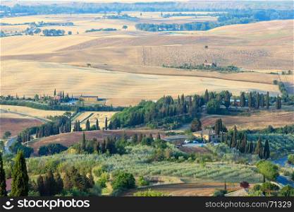 Beautiful landscape of Tuscany summer morning countryside from Pienza town walls. Typical for the Italy region Toscana farm houses, hills, wheat field, olives garden, vineyards, cypress passes.