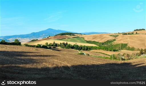 Beautiful landscape of Tuscany summer morning countryside in Montepulciano region. Typical for the Italy region Toscana hills, wheat field, olives garden, vineyards.