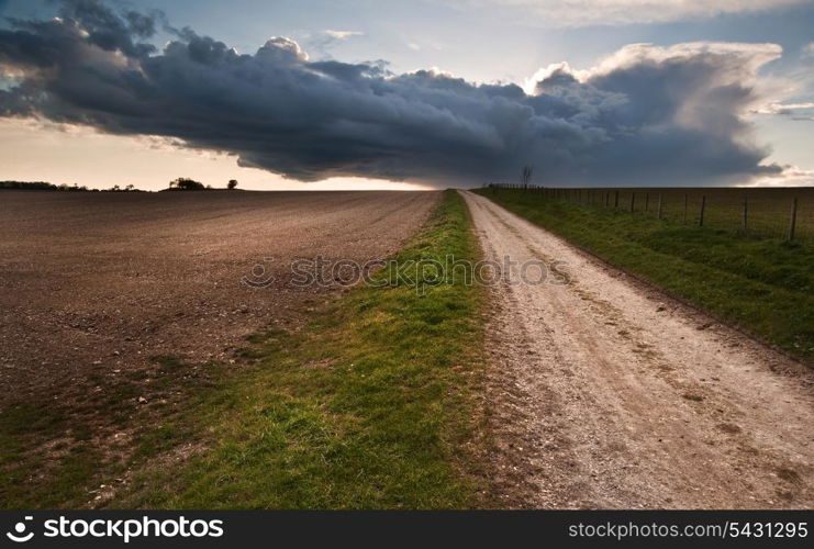 Beautiful landscape over agricultural fields with moody sky and invigorating sunlight