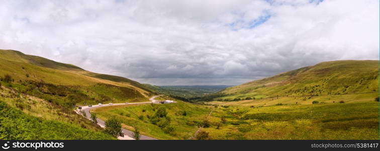 Beautiful landscape panorama across countryside to mountains in distance with moody sky