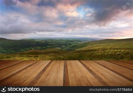 Beautiful landscape panorama across countryside to mountains with wooden planks floor