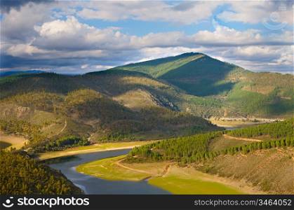 Beautiful landscape - river and mountains with trees -