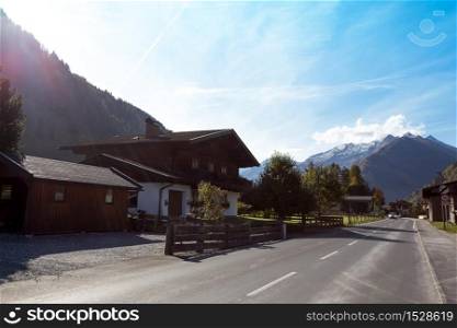 beautiful landscape. road through a small town in the mountains of austria. autumn