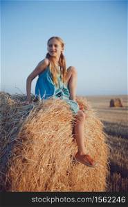 beautiful landscape - round bales and a girl in the field