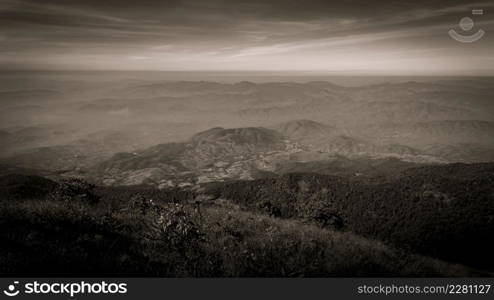 Beautiful landscape silhouette on the mountain peak during sunset with warm sunlight and dramatic sky. vintage tone