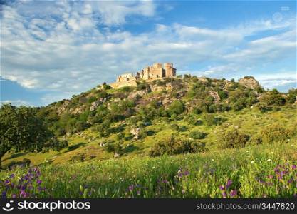 Beautiful landscape with a castle on a hill and a spectacular sky