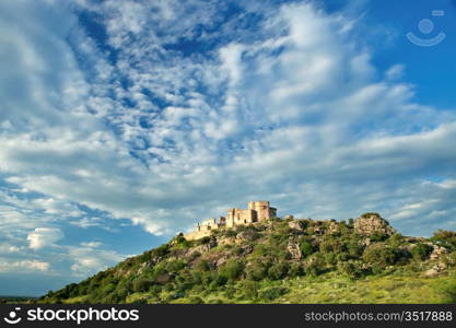 Beautiful landscape with a castle on a hill and a spectacular sky