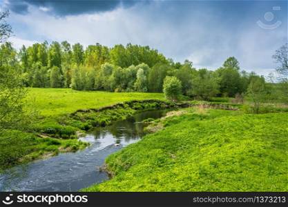 Beautiful landscape with a small river on a Sunny spring day.
